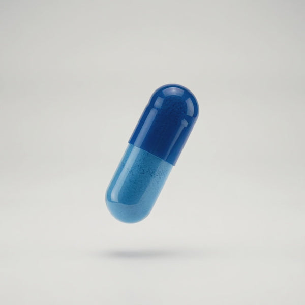 Uncaffed capsule opening revealing the ingredients powder inside.